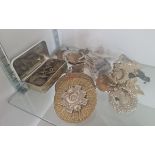 A collection of military cap badges and buttons.