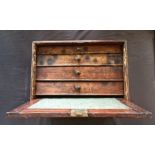 A four drawer toolbox chest with tools.