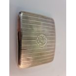 A hallmarked silver cigarette case, the rectangular design engine turned with central monogram