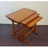 A nest of three Danish design teak tables.