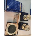 A pair of hallmarked silver filled candle holders, a hallmarked silver fronted clock, a silver