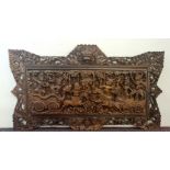 A carved wooden panel Indian battle scene.