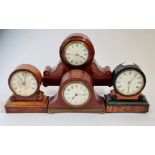 Four mantle clocks two mahogany and two walnut.