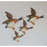 A set of four Beswick flying ducks.