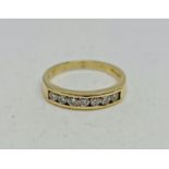 A hallmarked 18ct yellow gold diamond half eternity ring, channel set with seven round brilliant cut