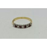 A hallmarked 18ct yellow gold ruby and diamond half eternity ring, set with five round brilliant cut