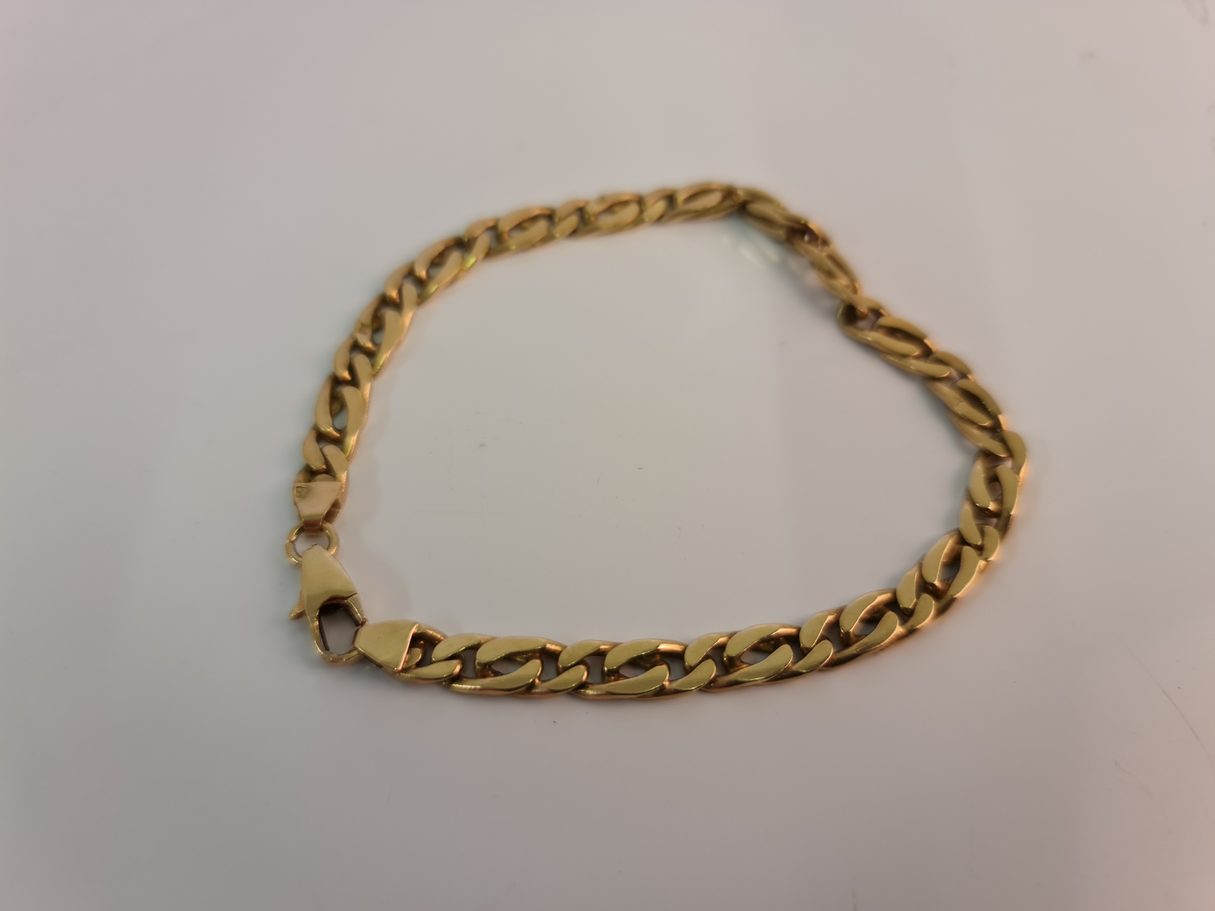 A curb link chain, yellow metal stamped with Arabic numeral, approx. length 19cm.