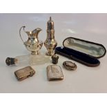 A collection of hallmarked silverware, to include a sugar shaker, milk jug, pill box, vesta cases
