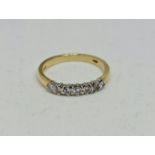A hallmarked 18ct yellow gold seven stone diamond ring, set with seven round brilliant cut diamonds,
