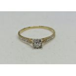 A hallmarked 9ct yellow gold diamond halo design ring, ring size P.
