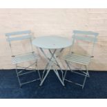 A bistro folding garden table and two chairs painted blue.