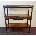 A Victorian rosewood dumbwaiter fitted with two drawers barely twist columns and three shelves.