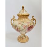 A Royal Bonn large two handled urn with lid, cream and gilt with a floral design. 41 cm.