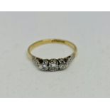 A three stone diamond ring, set with three graduated round cut diamonds, total diamond weight