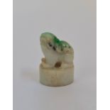 A carved Chinese pale green to dark jade foo dog seal pendant. 3cm.