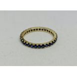 A sapphire full eternity ring, stamped 9k, ring size R1/2.