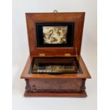 A walnut cased Symphonion style 24A no.111169 with inner glass lid and inlaid song birds in tree