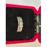 A diamond ring, set with a central princess cut diamond, measuring approx. 0.50ct, to a three band