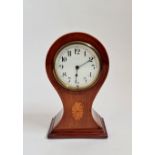 A mahogany balloon shaped mantle clock with inlaid border. 22 1/2 cm.