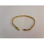 A circle link design bracelet, yellow metal stamped with Arabic numerals, (A/F), approx. length