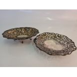 Two dishes, one of repousse floral design and the other of pierced foliage design, both stamped with