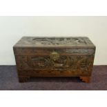 A small camphor wood blanket box with carved Oriental scene.