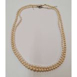 Two strings of pearls, one with diamond set clasp, the other clasp stamped 9ct, each one approx.
