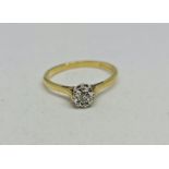 A hallmarked 18ct yellow gold diamond solitaire ring, star set with a round brilliant cut diamond,