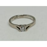 A hallmarked 18ct white gold diamond solitaire ring, set with a round brilliant cut diamond,
