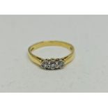 A hallmarked 18ct yellow gold three stone diamond ring, set with three graduated round brilliant cut