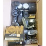 A box containing a quantity of Olympus camera accessories lenses flash etc.