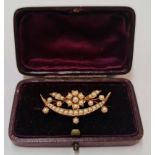 A Victorian seed pearl brooch, of crescent and floral design, indistinctly stamped (possibly '15').