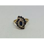 A sapphire and diamond dress ring, the open metalwork curved design set with marquise and round