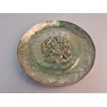 A Chinese presentation plate, featuring central repousse dragon and fish design, surrounded by