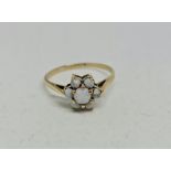 An opal cluster ring, stamped 9ct, ring size P.