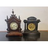 A gothic style mantle clock with a black painted mantle clock.