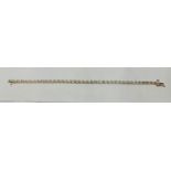A hallmarked 9ct yellow gold diamond bracelet, each flower design link set with a diamond accent and
