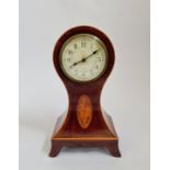 A mahogany balloon shaped mantle clock with inlaid border and shell to front. 28cm.