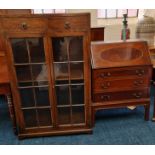 An oak glazed bookcase with a walnut bureau.