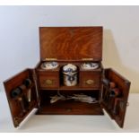 An oak carved pipe smokers cabinet with pipes.