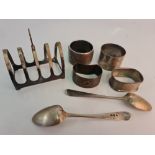 A selection of hallmarked silverware to include four napkin rings, two teaspoons initial M & A on