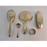 A collection of hallmarked silverware to include a hand mirror, hairbrush and clothes brush dressing