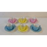 A set of six Shelley coffee cups and saucers yellow pink and blue.