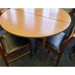 A mid century teak dining table and four chairs.