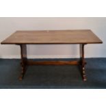 A distressed oak refectory dining table with carved rose to base. 152 cm.