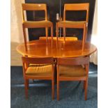 A mid century teak dining table and six chairs.