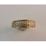 A band ring of three rows of diamond accents, ring size L 1/2, approx. weight 2.8gms