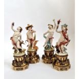 A set of the four seasons Capodimonte Tyche Tosca cherubs on brass bases. Approx 33 1/2 cm.