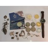 A collection of various commemorative coins with a Gent's wristwatch on leather strap and a