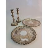 A collection of silver plated ware to include, two savers, and a pair of candle sticks